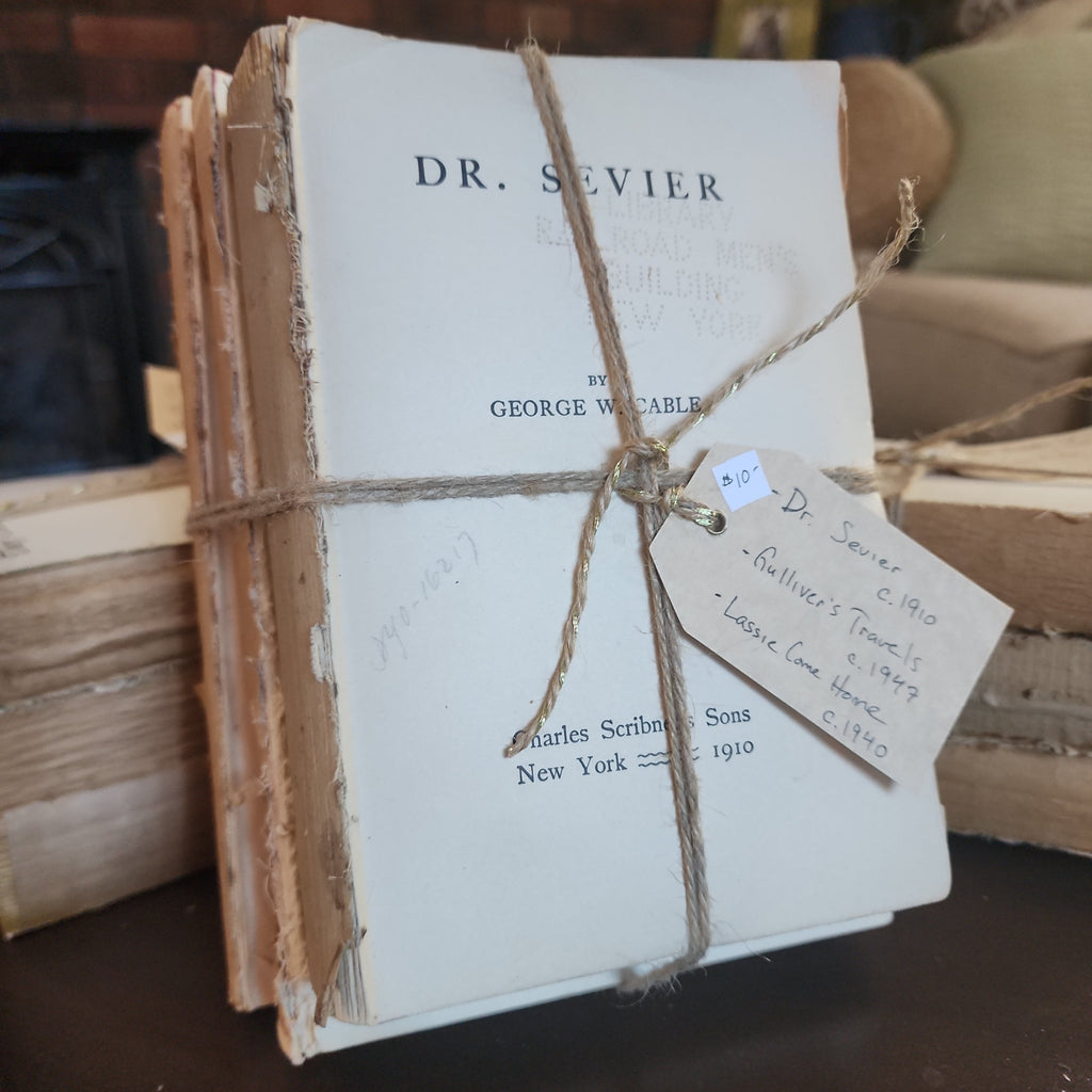 Antique book bundle wrapped in jute twine on rustic table | The Olde 1840