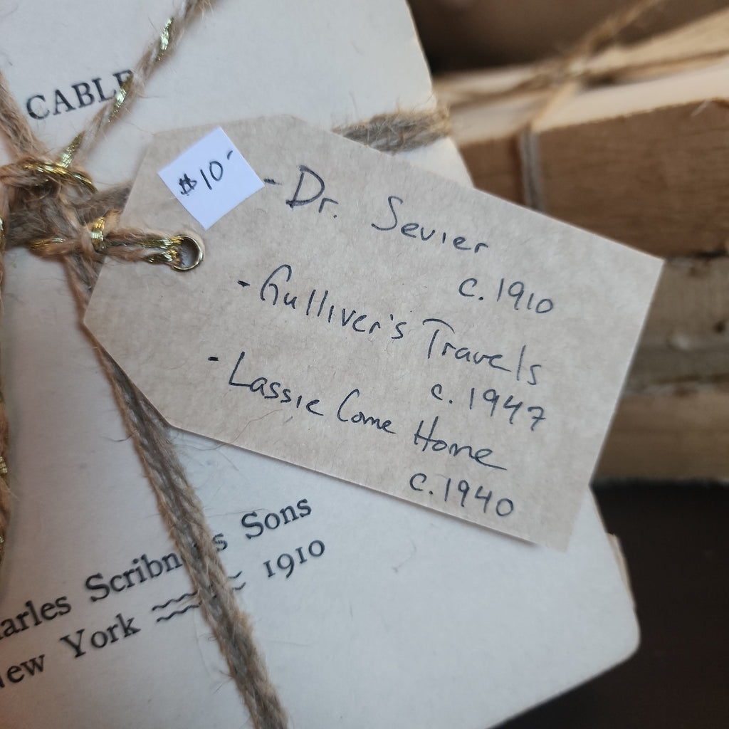 Rustic book bundle tied with decorative jute on table | The Olde 1840