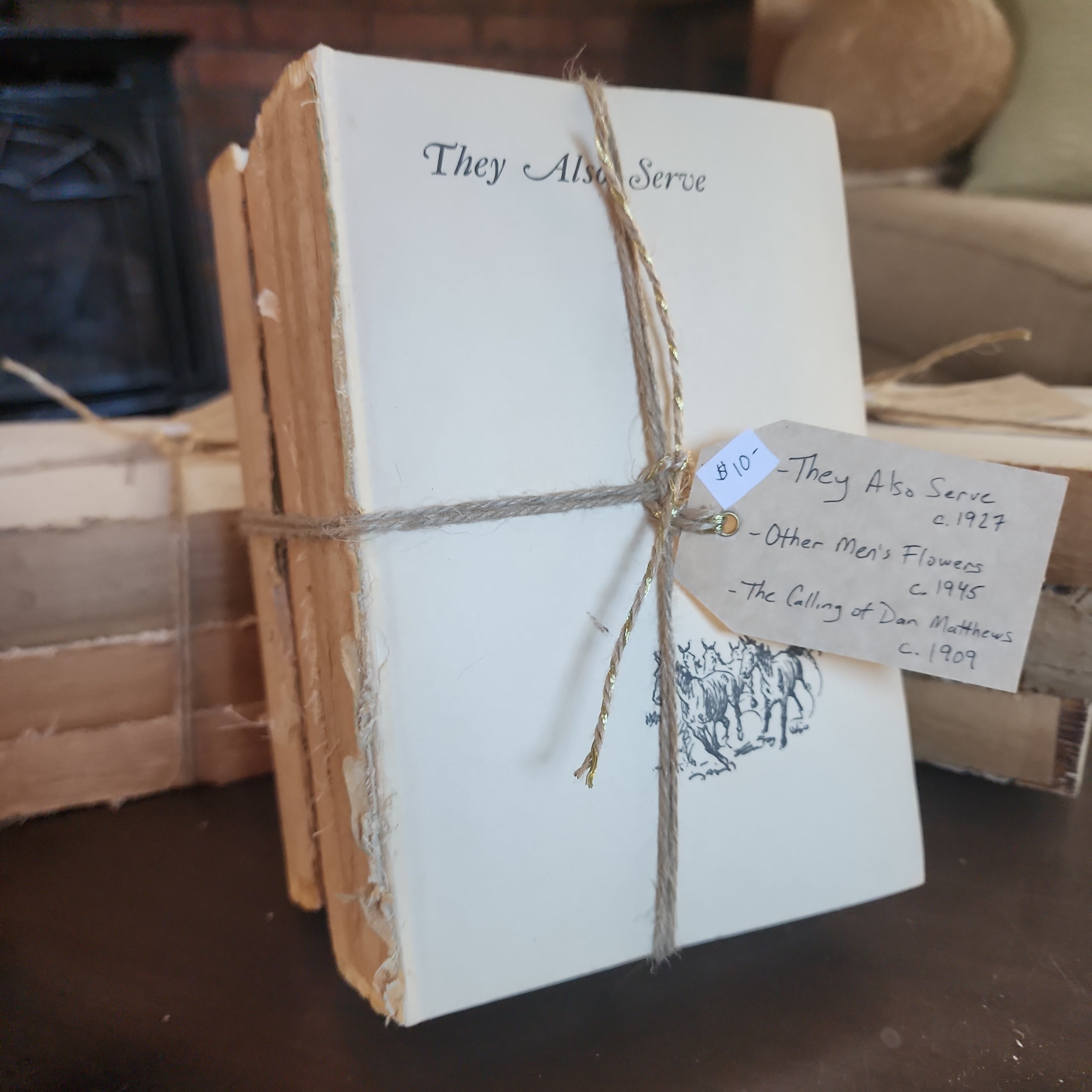 Hand-tied bundle of old books placed on wooden tabletop | The Olde 1840