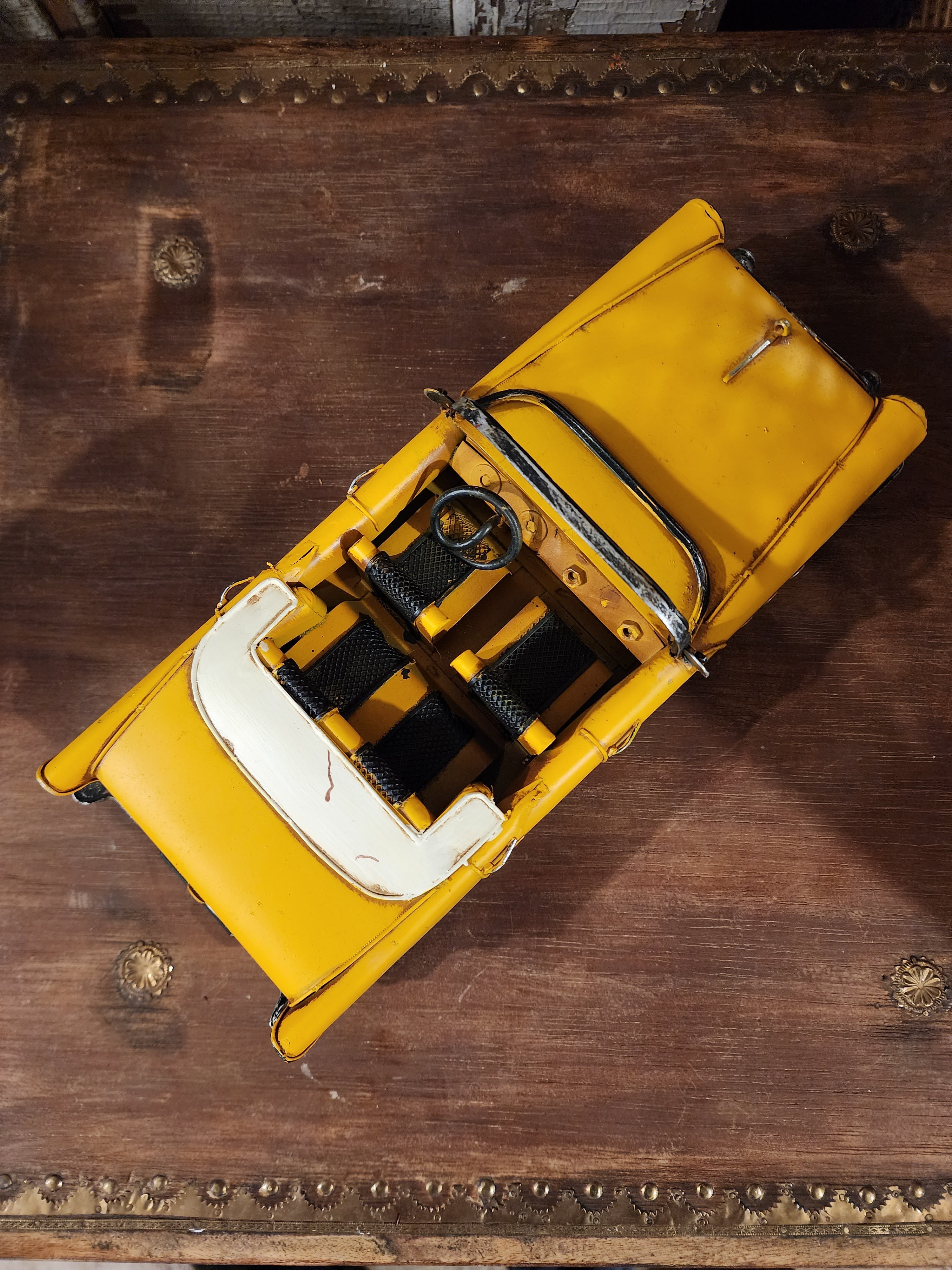 Miniature retro metal car displayed as decorative home accent piece