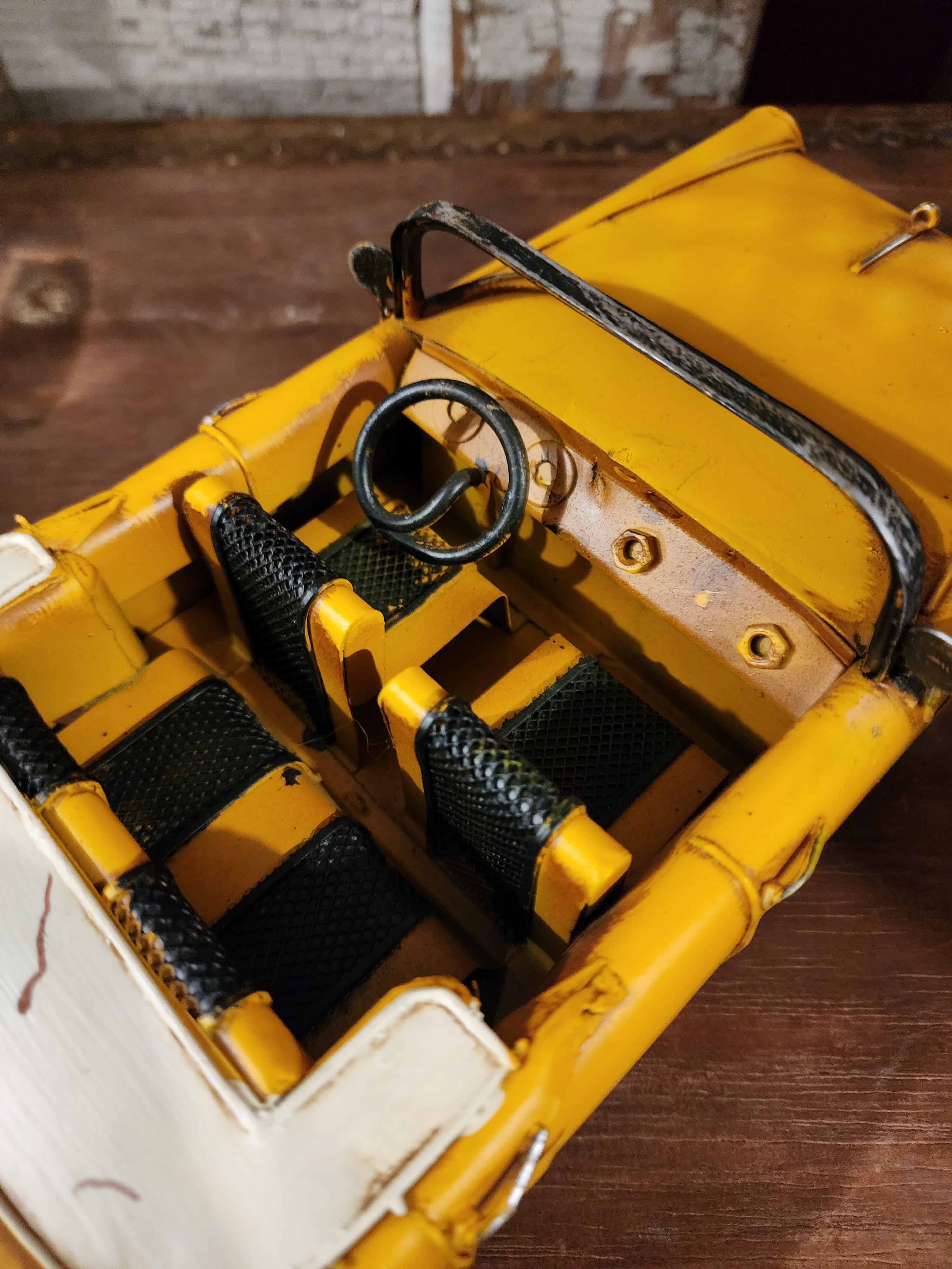 Weathered metal vintage vehicle sculpture with handcrafted detailing