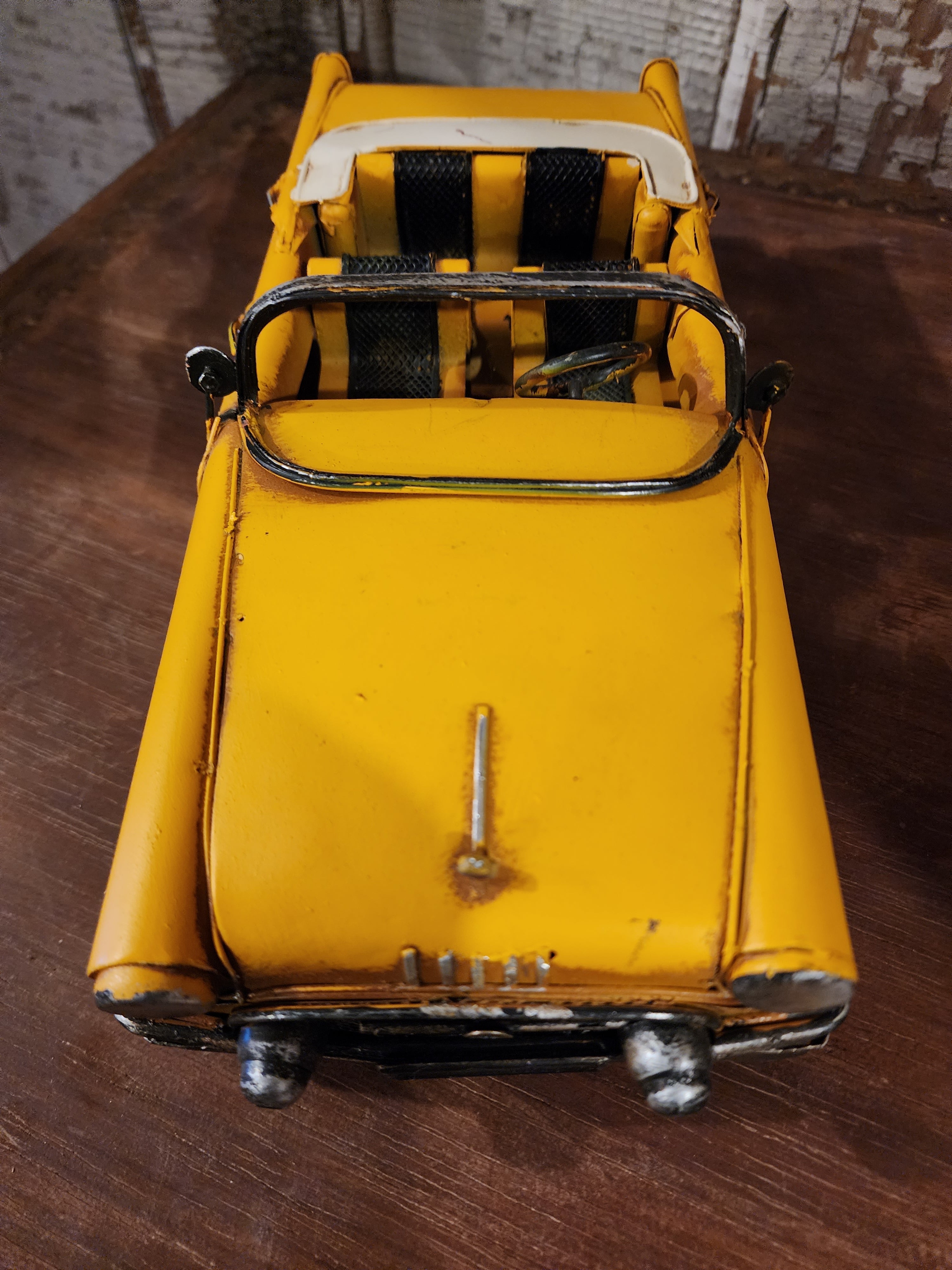 Detailed metal vintage car figurine with classic rounded body design