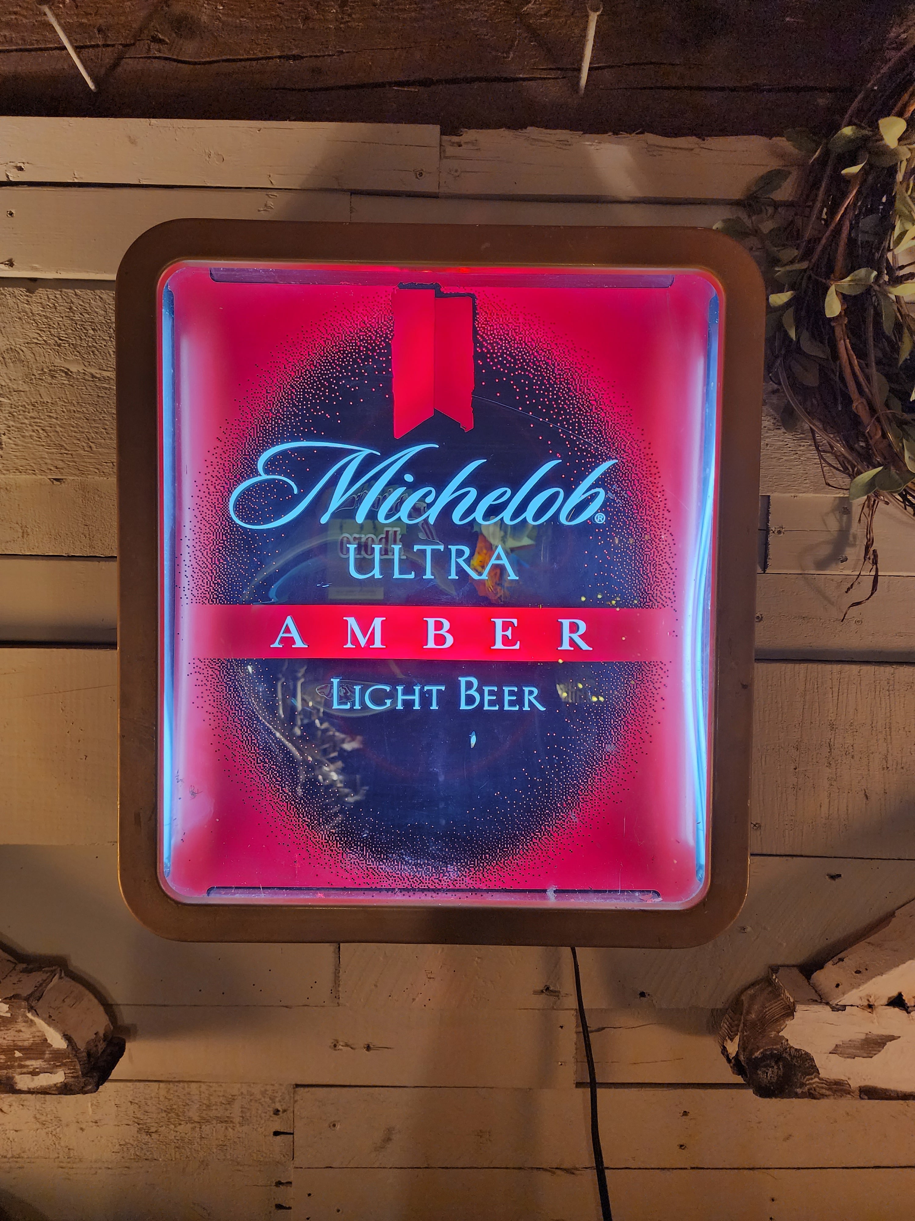 Michelob Ultra neon light sign glowing in red and blue colors | The Olde 1840