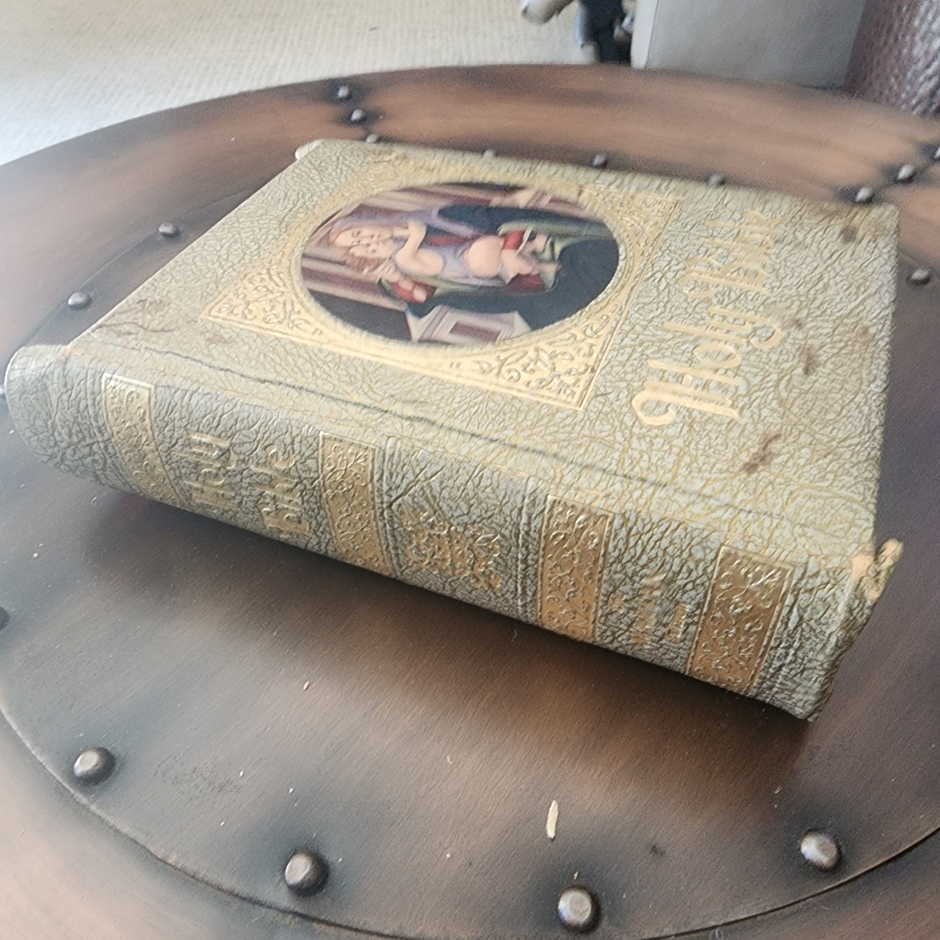 Angled view of vintage Holy Bible showing textured gold cover | The Olde 1840