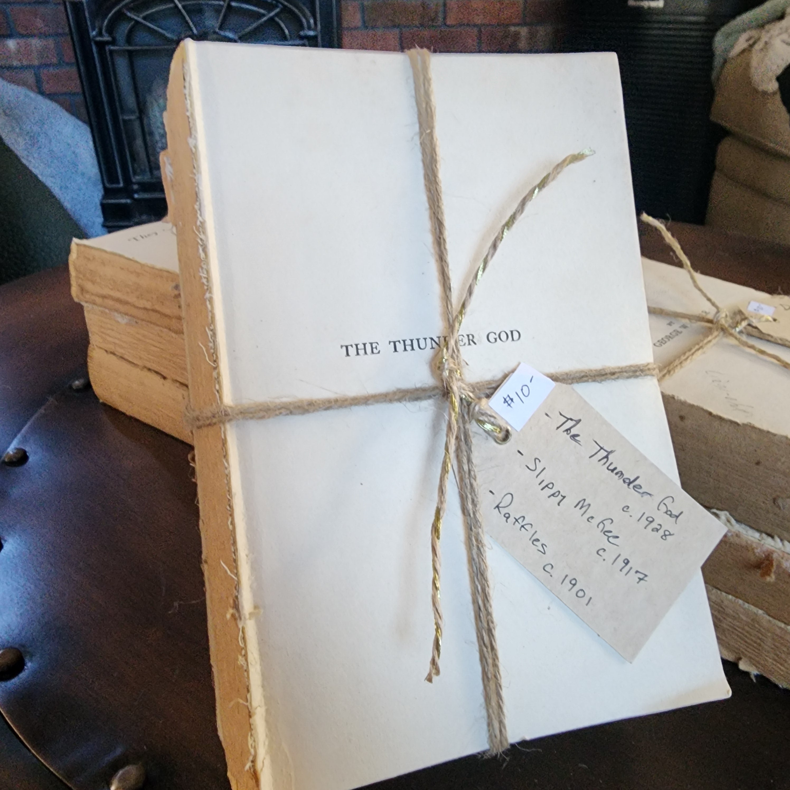 Close-up of antique book spines wrapped in twine | The Olde 1840