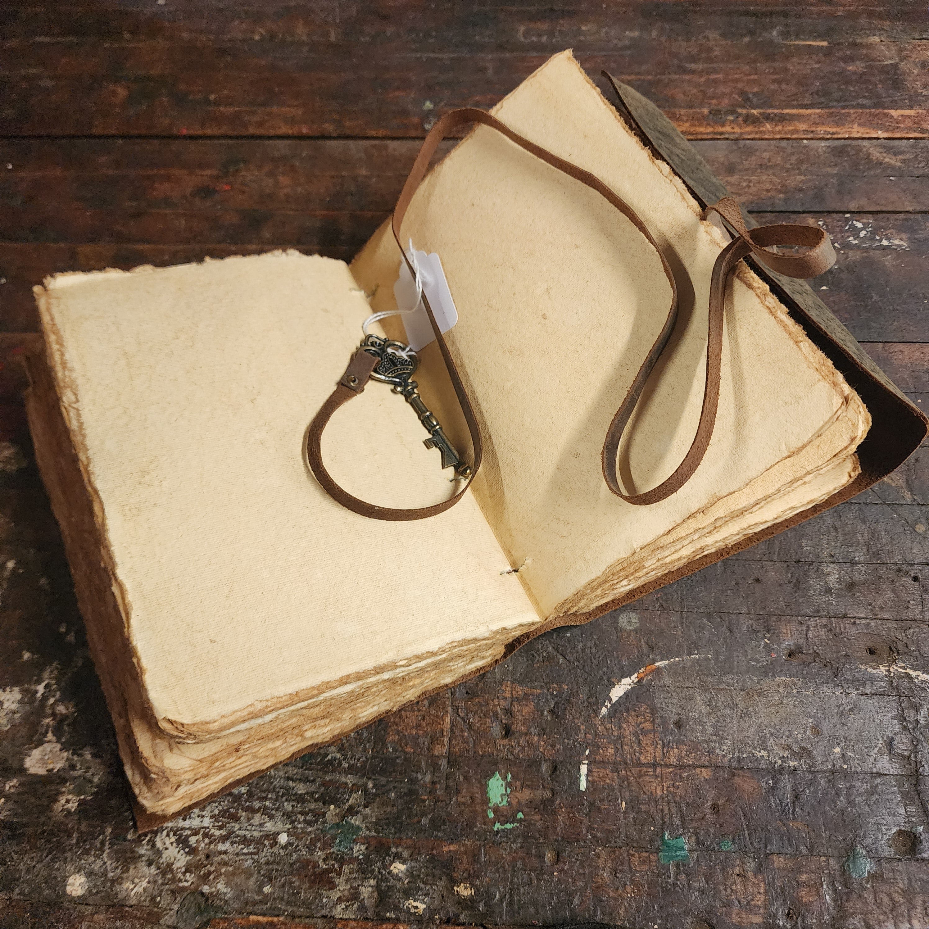 Leather journal displayed with rustic writing accessories|  The Olde 1840