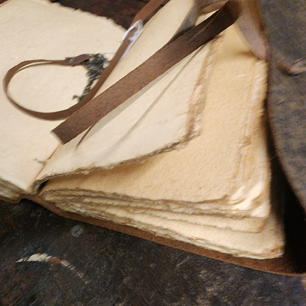 Leather journal displayed with rustic writing accessories | The Olde 1840