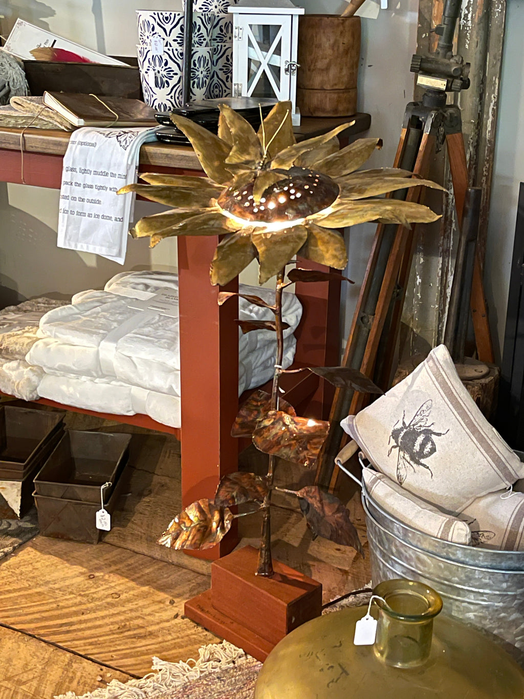 Handcrafted brass and copper sunflower accent light on wooden base