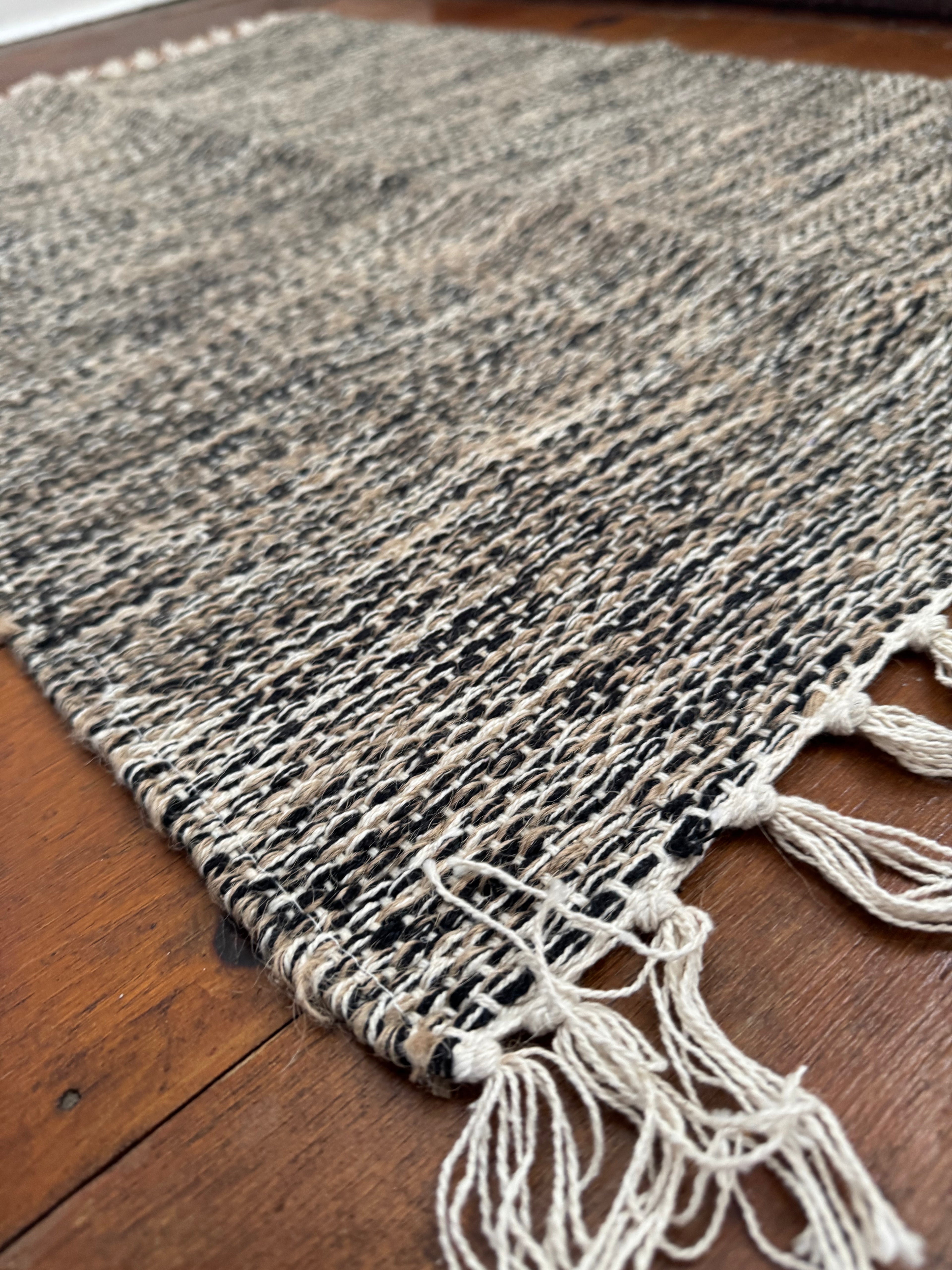 Neutral boho woven rug with fringe tassels black and beige
