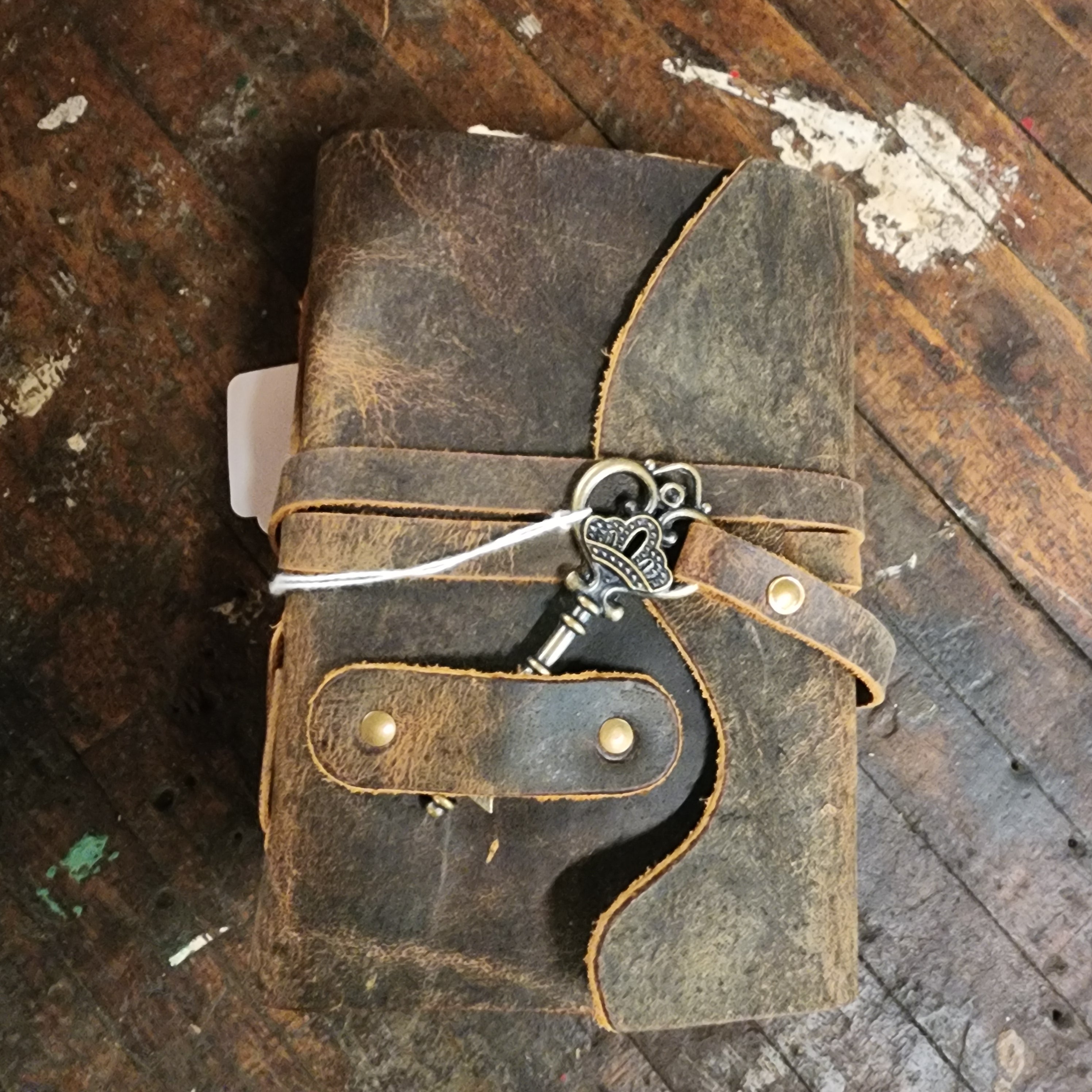 Distressed walnut leather journal on wood table